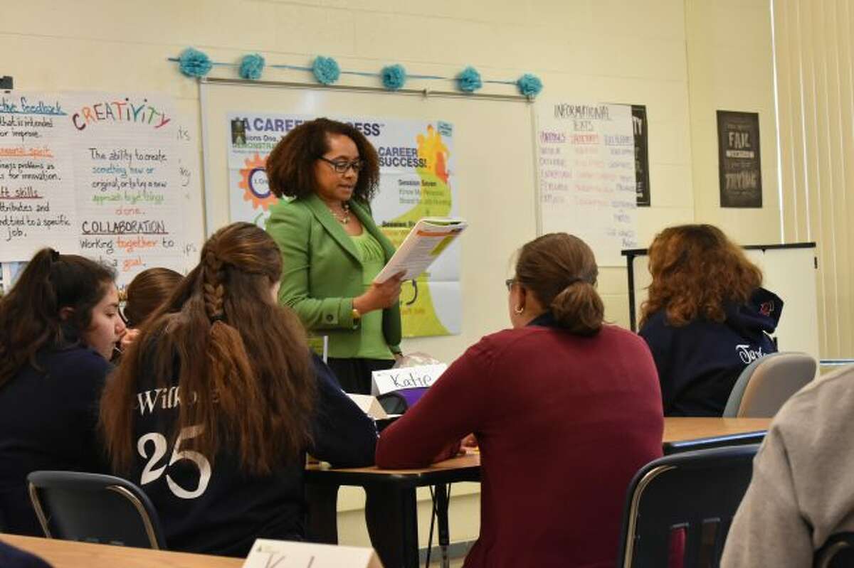 4Front Credit Union's Tamara DePonio leads Manistee Catholic Central Middle School students through a session of the Junior Achievement Economics for Success program. (Courtesy photo)