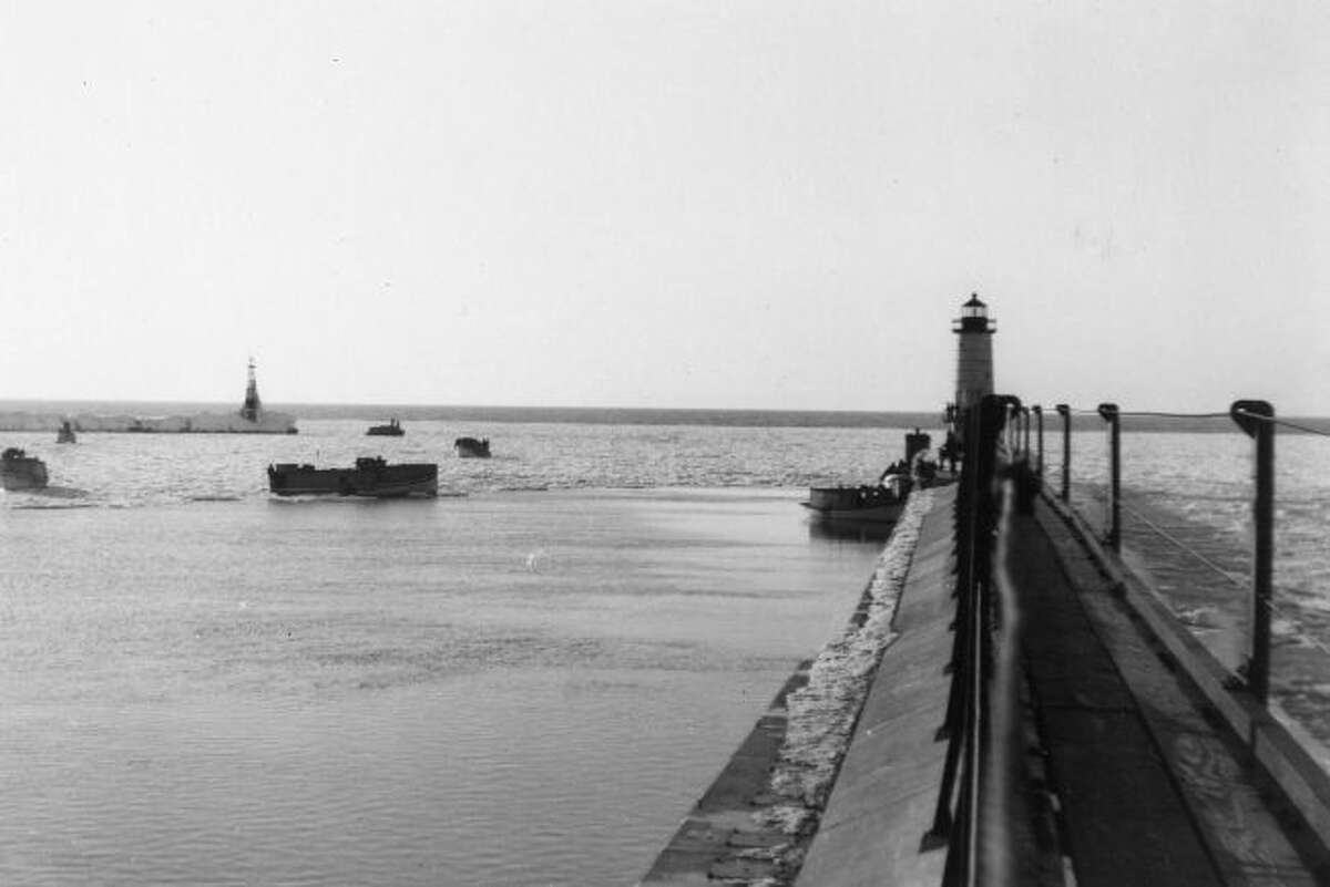 This 1940s photograph shows the view down the catwalk at Fifth Avenue Beach lighthouse leading out to the lighthouse.