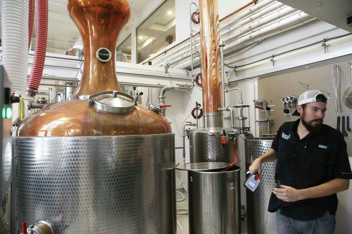Tyler Goggans checks distilling operations at Maverick Distillery.