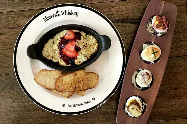 Goat cheese and strawberries served in a cast-iron dish and a flight of deviled eggs from Maverick Whiskey