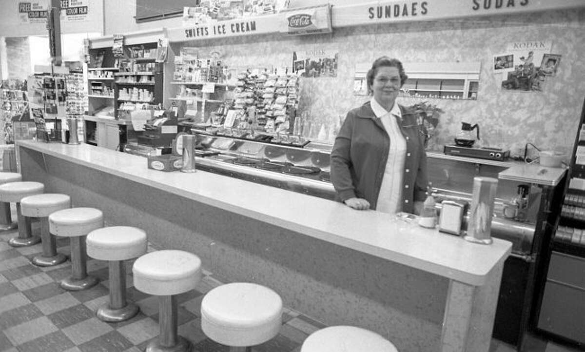 Charlotte Franckowiak stands behind the counter the last drug store soda fountain in Manistee in February, 1981. The soda fountain, formerly located at 359 River St., ceased operation when Saylor’s Rexall Pharmacy closed.