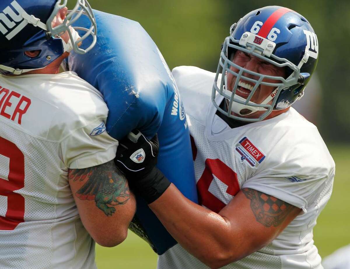 New York Giants offensive lineman David Diehl (66) performs a drill with teammate Jacob Bender during NFL football training camp in Albany, N.Y., on Monday, Aug. 2, 2010. (AP Photo/Mike Groll)