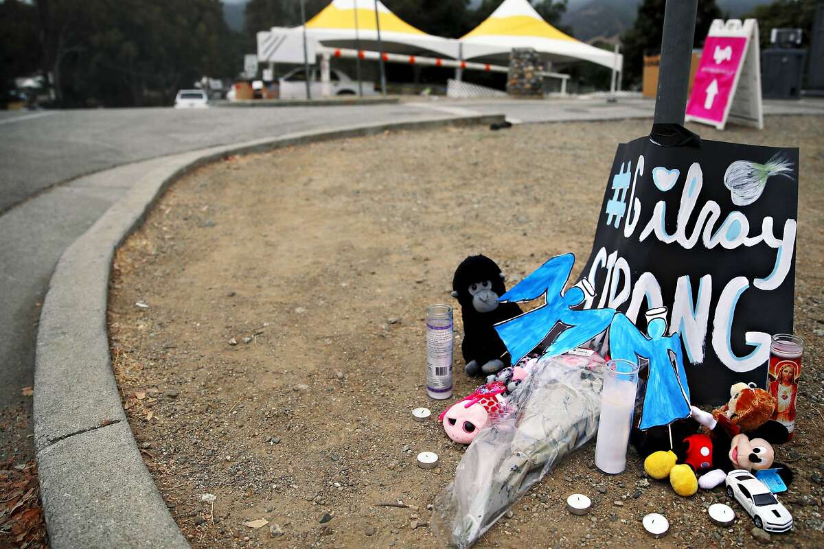 A memorial with stuffed animals, candles, a toy car and a poster stating "Gilroy Strong" rests at the corner of Miller Ave. and Uvas Park Dr., near the entrance of Debell Uvas Creek Park Preserve, in Gilroy, Calif., on Tuesday, July 30, 2019. The space is dedicated to lives lost Sunday during the Gilroy Garlic Festival.