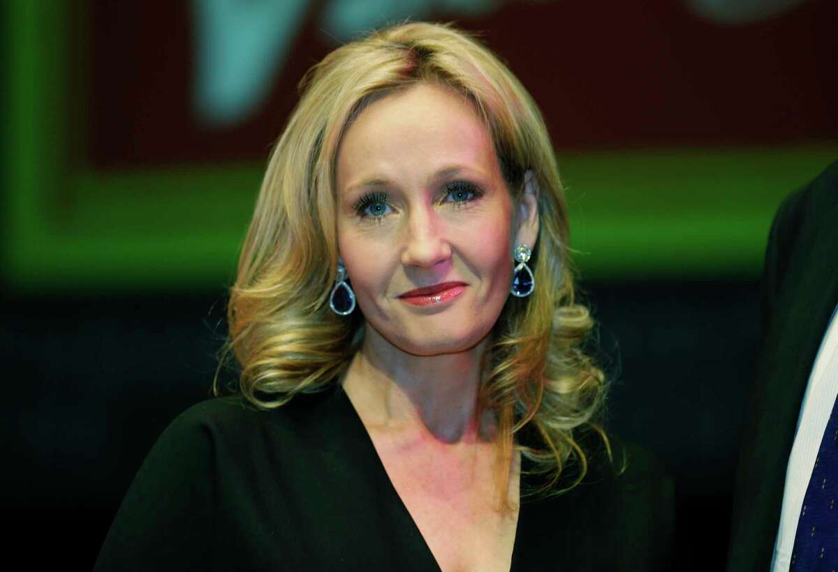 British writer J.K. Rowling poses for photographers during a photo call to unveil her new book, entitled: 'The Casual Vacancy', in London. The Harry Potter author says she'll publish a children's story online Tuesday. (AP Photo/Lefteris Pitarakis, File)