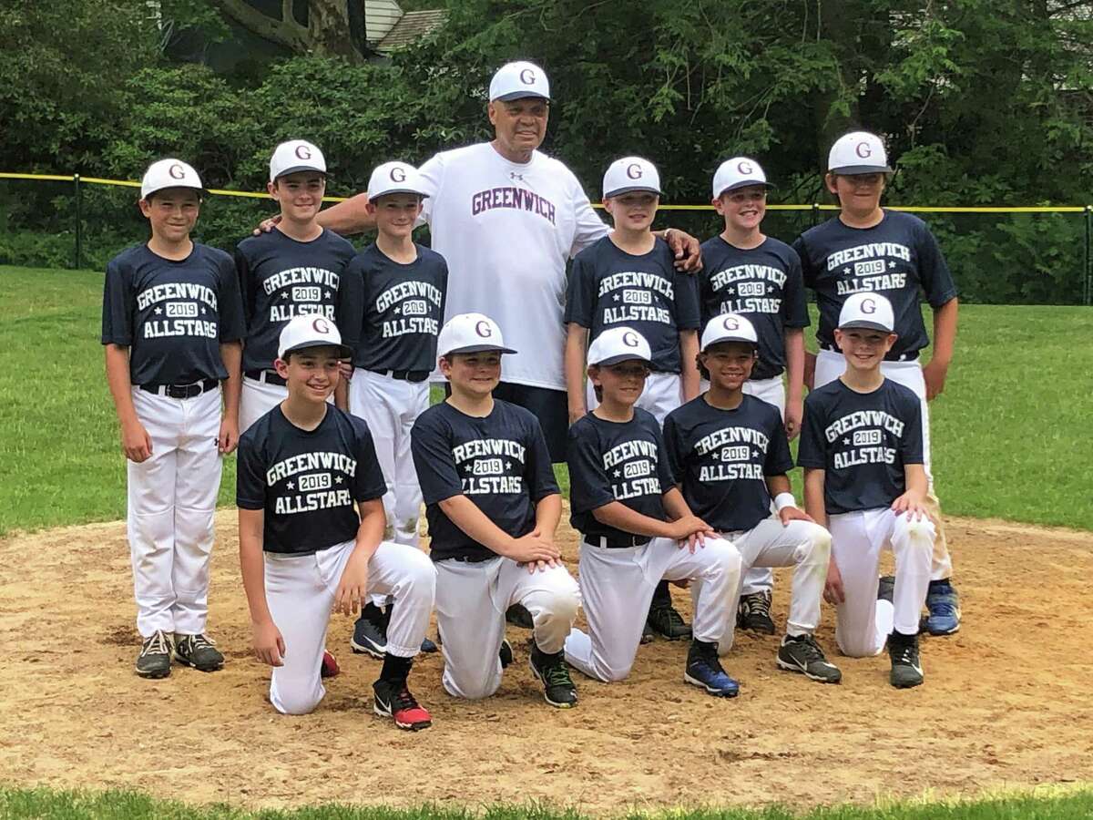 Hall of Fame baseball player Reggie Jackson, center, visited one of the Greenwich Cal Ripken 10-year-old All-Star team’s practices last month in Greenwich.