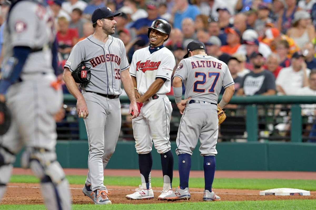 CLEVELAND, OHIO - JULY 30: Starting pitcher Justin Verlander #35 and Jose Altuve #27 of the Houston Astros talk with Francisco Lindor #12 of the Cleveland Indians on first during an instant replay challenge during the sixth inning at Progressive Field on July 30, 2019 in Cleveland, Ohio. (Photo by Jason Miller/Getty Images)