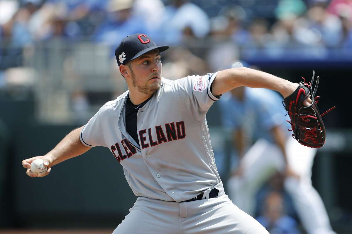 Cleveland Indians pitcher Trevor Bauer throws against the Kansas City Royals in the first inning of a baseball game at Kauffman Stadium in Kansas City, Mo., Sunday, July 28, 2019. (AP Photo/Colin E. Braley)