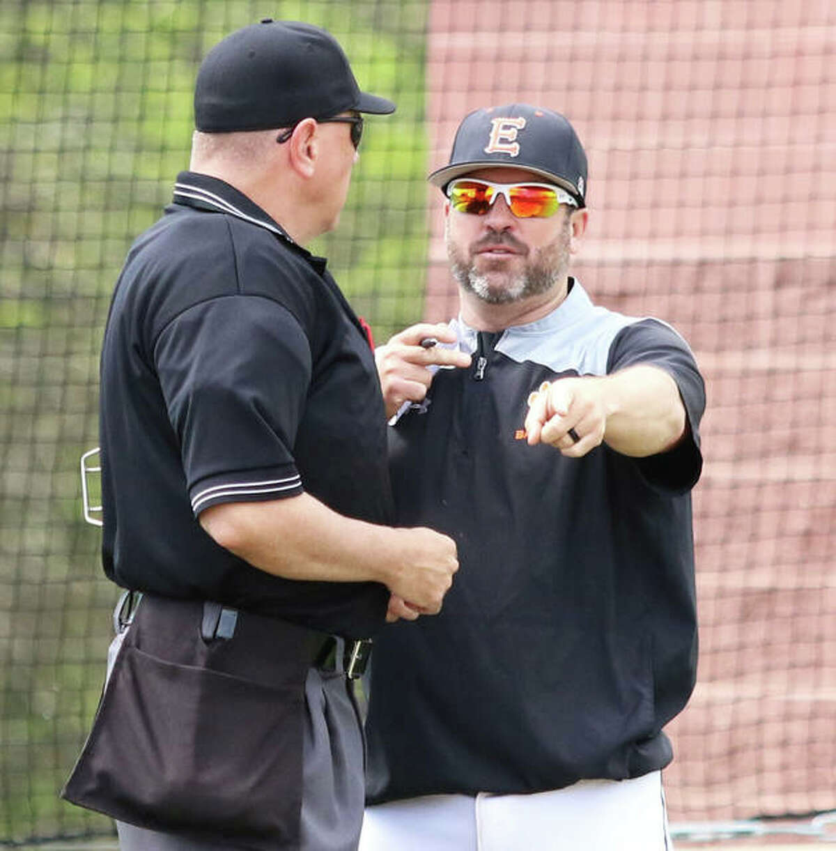 Edwardsville coach Tim Funkhouser (right), shown making a point to the plate umpire during a game at Alton High on April 22, is the 2019 Telegraph Large-Schools Baseball Player of the Year.