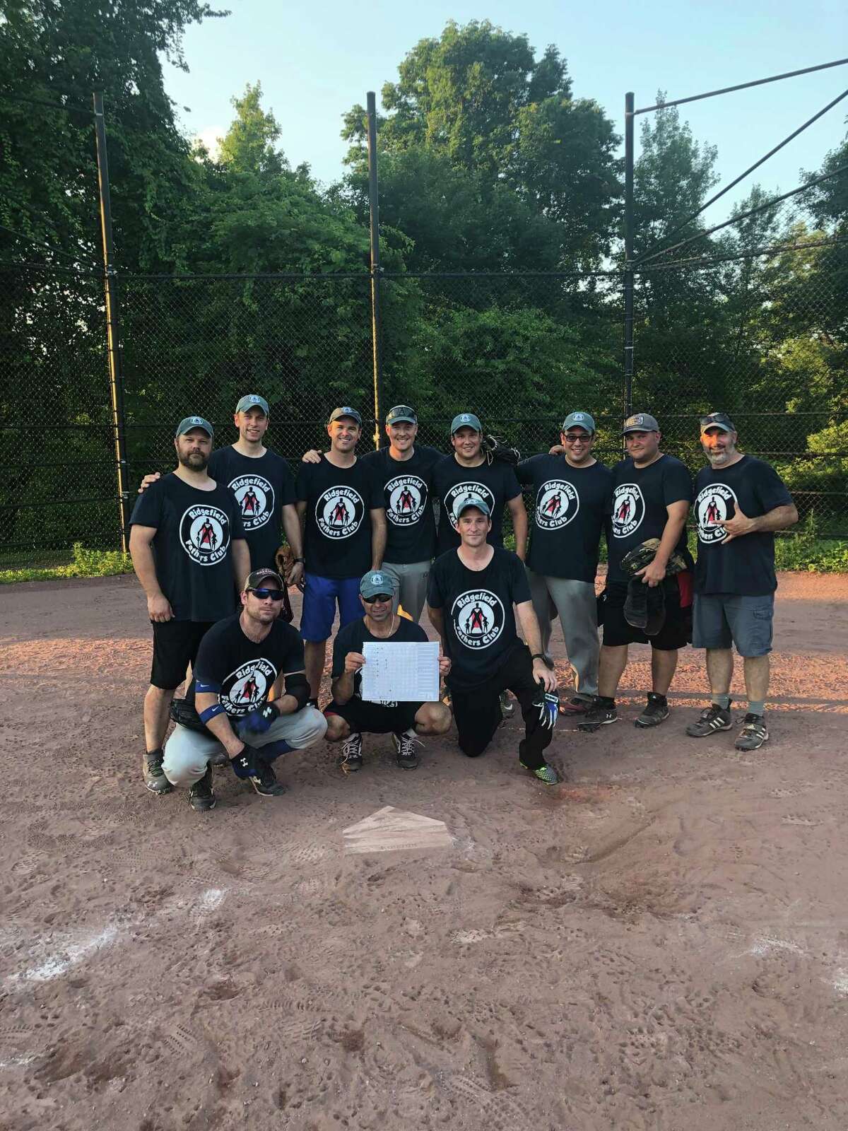 Started after a Facebook post, the Ridgefield Fathers Club softball team gathers for a post-game photo. Back row (left to right): Justin DiGrazia, Adrian Thibodeau, Jason Smith, Paul Dyer, Ed Winstanley, Aaron Lockwood, Joe Attonito, Tony Grau; bottom row: Charlie Taney, Mike Schmer, Dave Parsons.