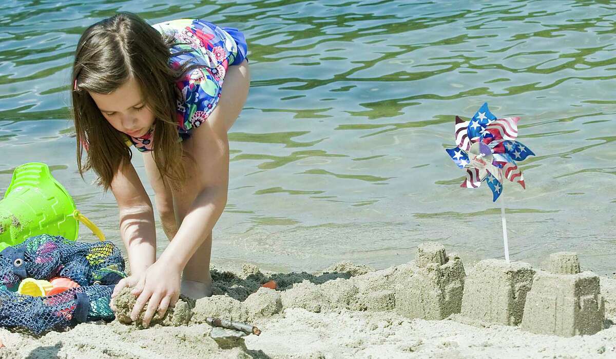 Alyssa Bello, 9 of Ridgefield, extends the wall to her patriotic castle at Martin Park Beach in Ridgefield for the Ridgefield Parks and Rec annual sand castle competition. Monday, July 4, 2016
