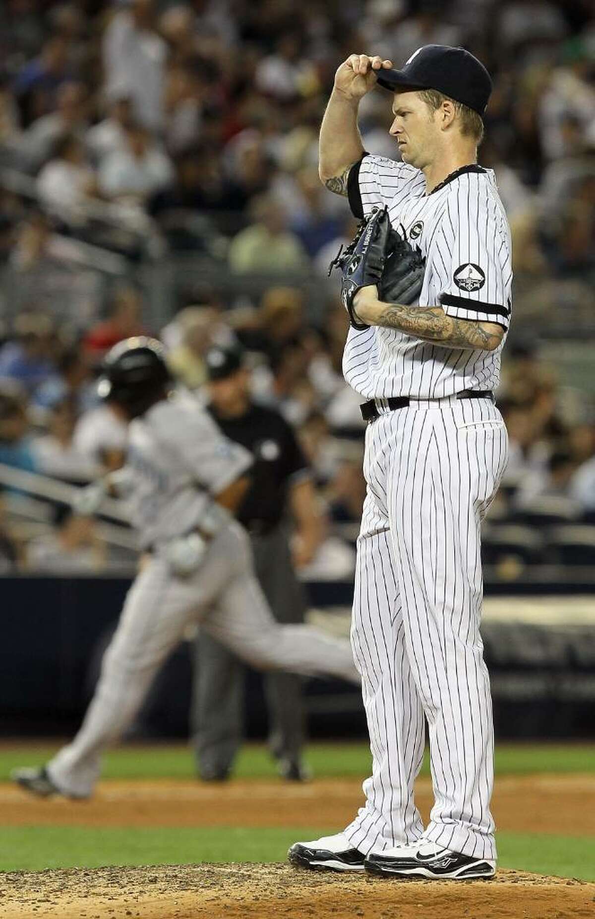 NEW YORK - AUGUST 02: A.J. Burnett #34 of the New York Yankees reacts during the fifth inning after surrendering a two run home run to Edwin Encarnacion #12 of the Toronto Blue Jays on August 2, 2010 at Yankee Stadium in the Bronx borough of New York City. (Photo by Jim McIsaac/Getty Images) *** Local Caption *** A.J. Burnett;Edwin Encarnacion