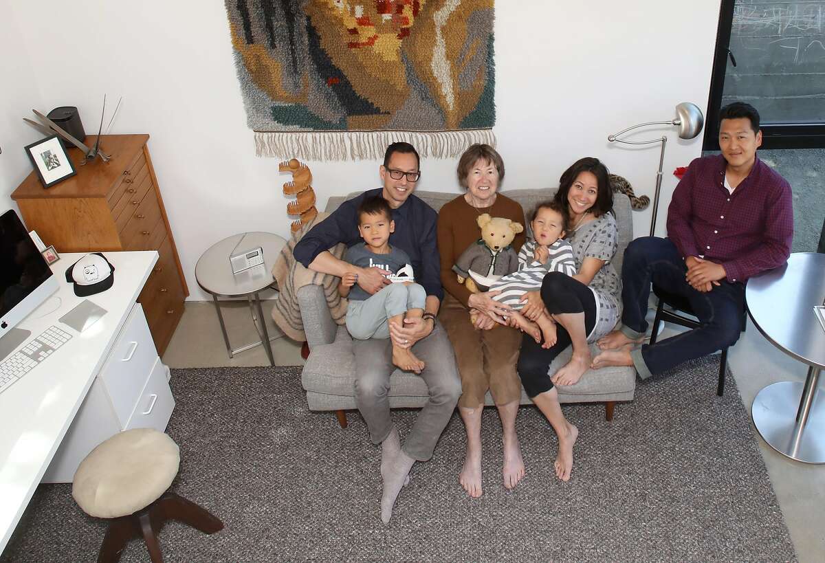 View of the living room at �Kleines Haus,� a simple, sleek tiny home designed by Peter Liang (left) carrying his nephew Otto, his mother, Irmhild Liang (middle), Stephanie Liang Chung (right) carrying her daughter Liezl, and her husband Mike Chung (right) seen on Thursday, July 18, 2019 in Oakland, Calif.