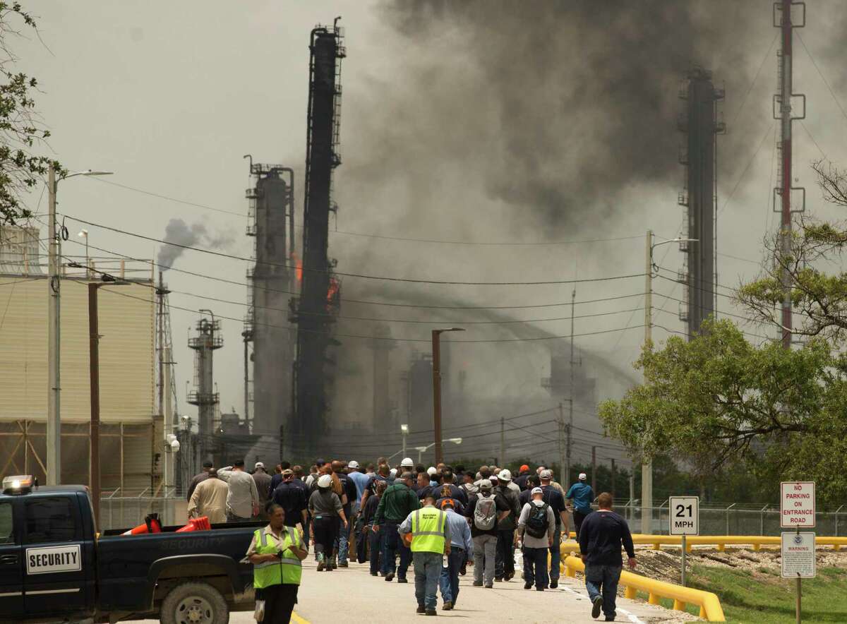 Evacuated ExxonMobil plant workers go back to the campus after the explosion fire is contained on Wednesday, July 31, 2019, in Baytown.