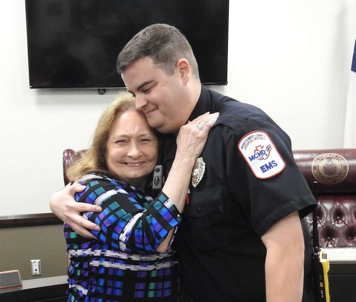 Spring resident Evelyn Huddleston hugs MCHD paramedic Spencer Lantz at a reunion with the first responders who helped save her after she suffered a cardiac arrest recently.