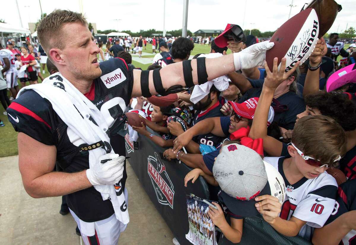 Houston Texans defensive end J.J. Watt (99) signs autographs during training camp at the Methodist Training Center on Thursday, Aug. 1, 2019, in Houston.
