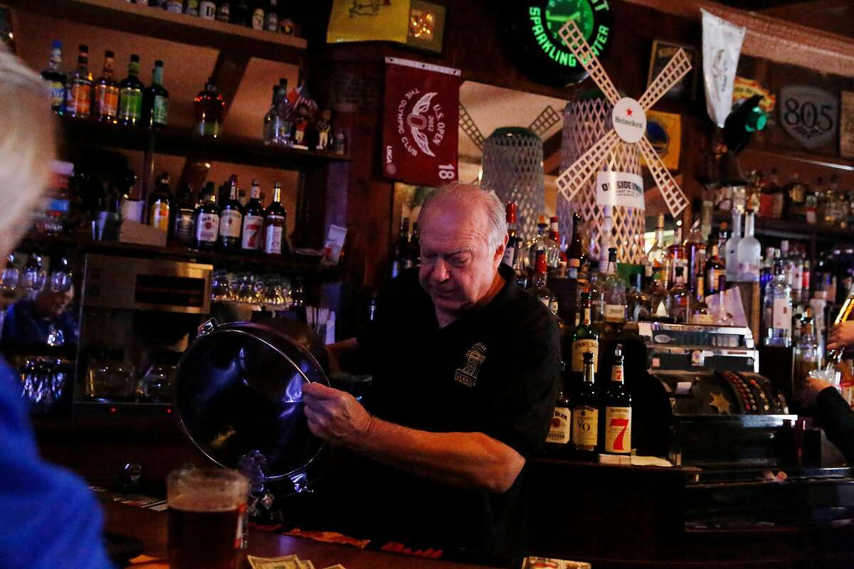 Don Gorwky, owner, pours ice from a bucket while working at Portals Tavern on Wednesday, July 31, 2019 in San Francisco, Calif.