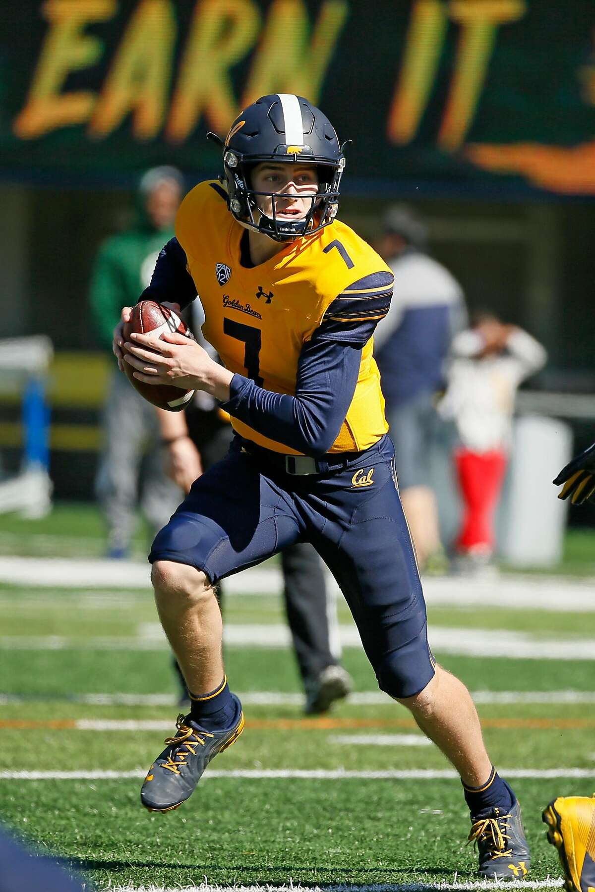 California Golden Bears quarterback Chase Garbers (7) keeps the ball on a read-option play during the annual Cal Spring Football Game at California Memorial Stadium on Saturday, March 16, 2019, in Berkeley, Calif.