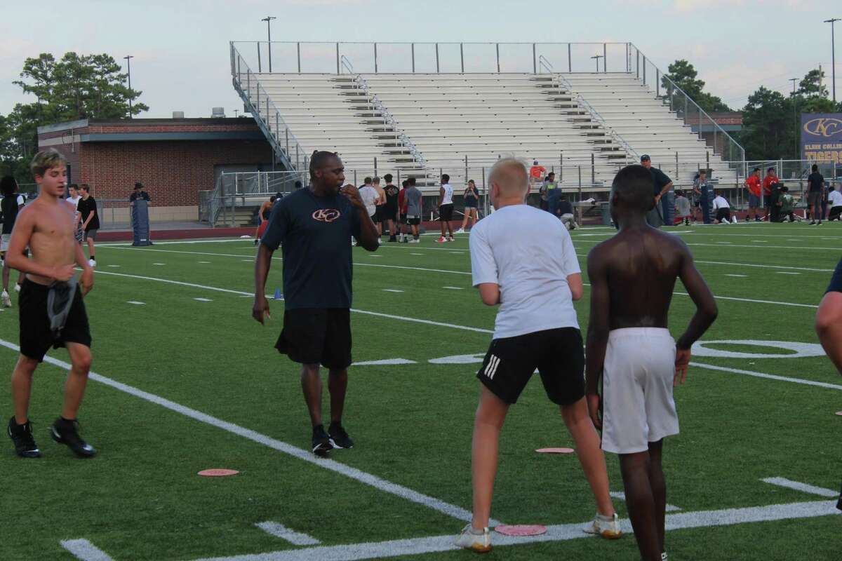 Klein Collins football coach Cliff Robinson works on tackling drills with campers during the KC Tiger football camp for incoming 6th-9th graders, July 29-Aug. 1, at Klein Collins High School.