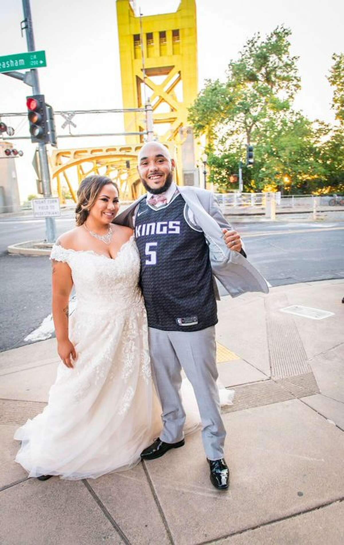 Anthony Carmichael shows off his Sacramento Kings jersey in this wedding photo with his wife Lanissa Carmichael.