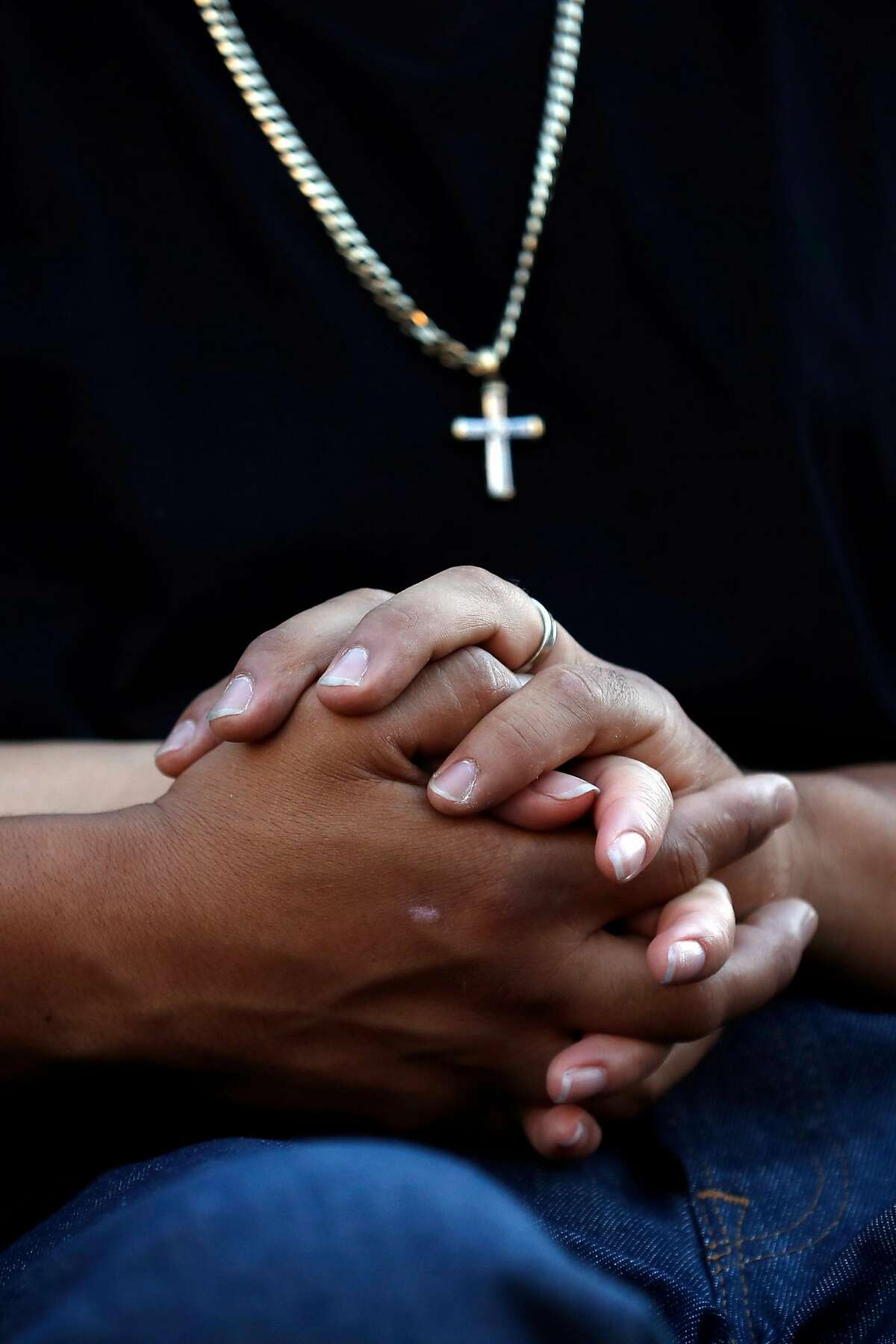 In the wake of Sunday's mass shooting at the Gilroy Garlic Festival, a couple, who declined to be identified, hold hands during a vigil on Monterey Street in Gilroy, Calif., on Thursday, August 1, 2019.
