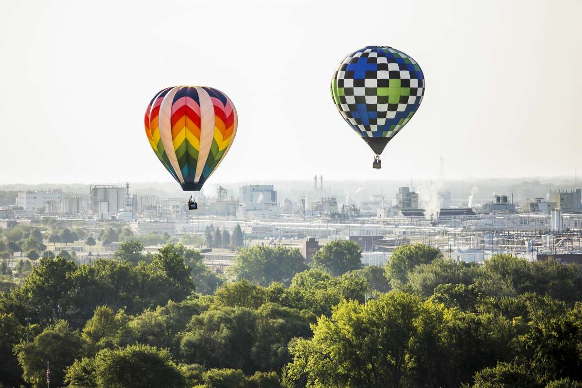 Hot air balloon pilots take an early morning flight as part of the Midland Balloon Fest on Friday, Aug. 2, 2019. (Katy Kildee/kkildee@mdn.net)