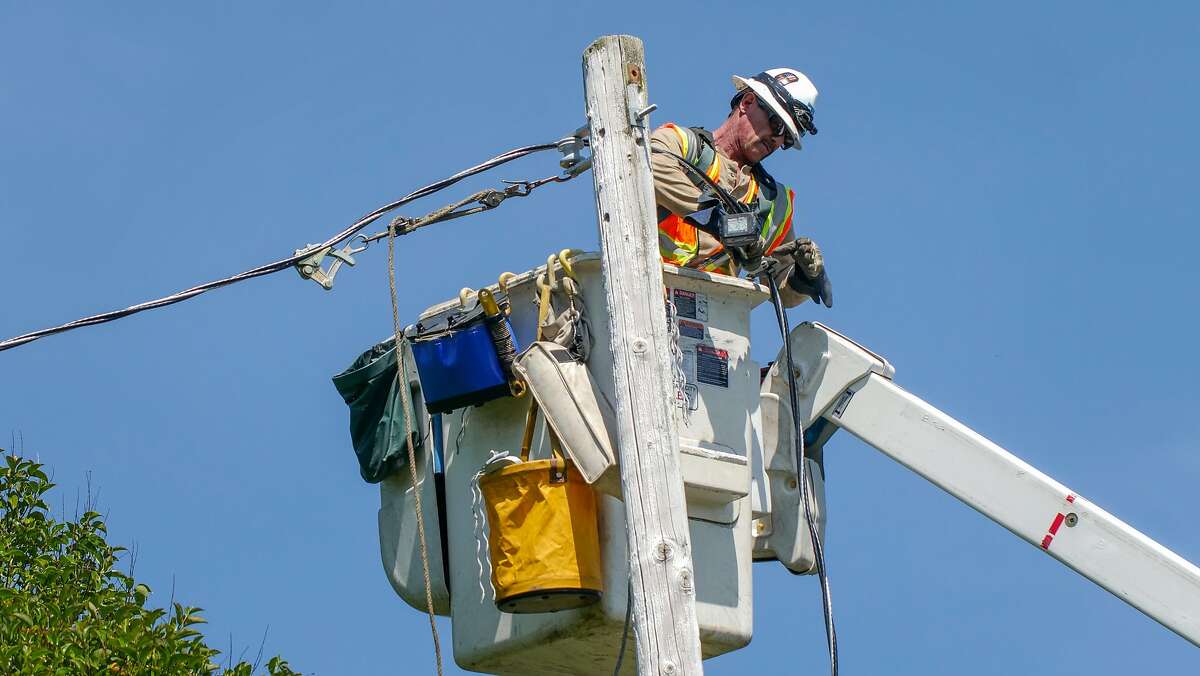PG&E lineman, Vic Torino pull lines as a part of the routine repairs along Hall Road, Wednesday May 29, in Santa Rosa, CA.