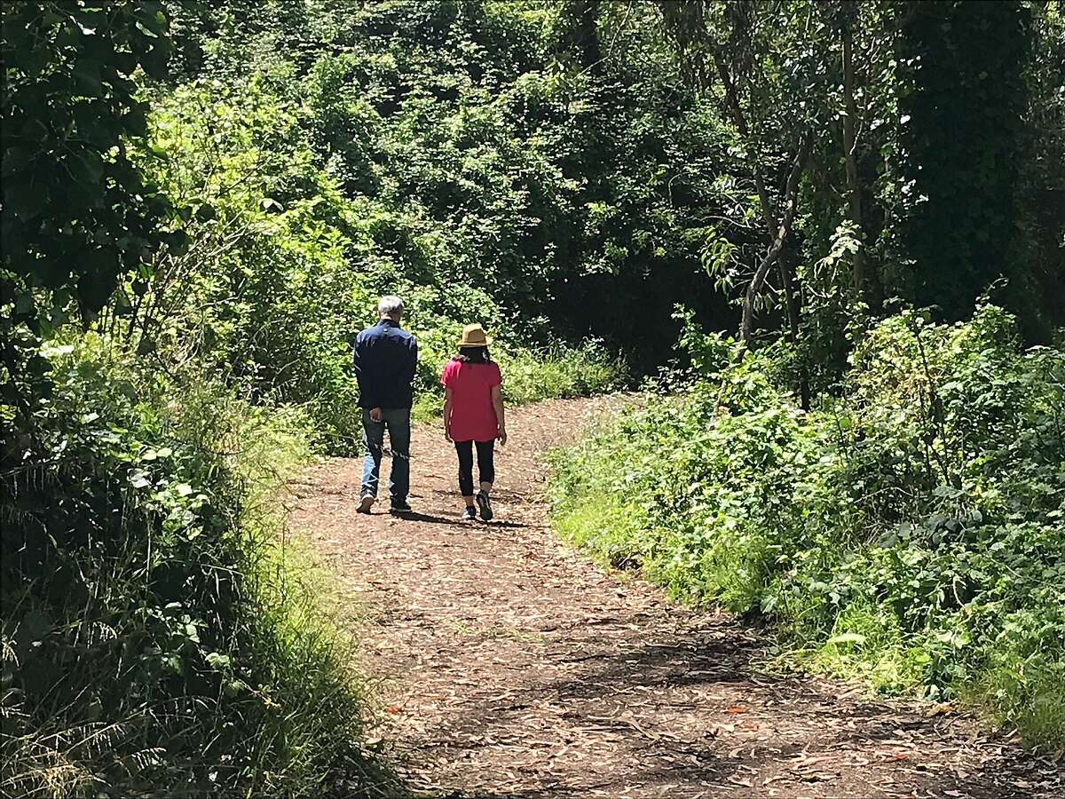 A couple walk the trail on Mt. Davidson in San Francisco.