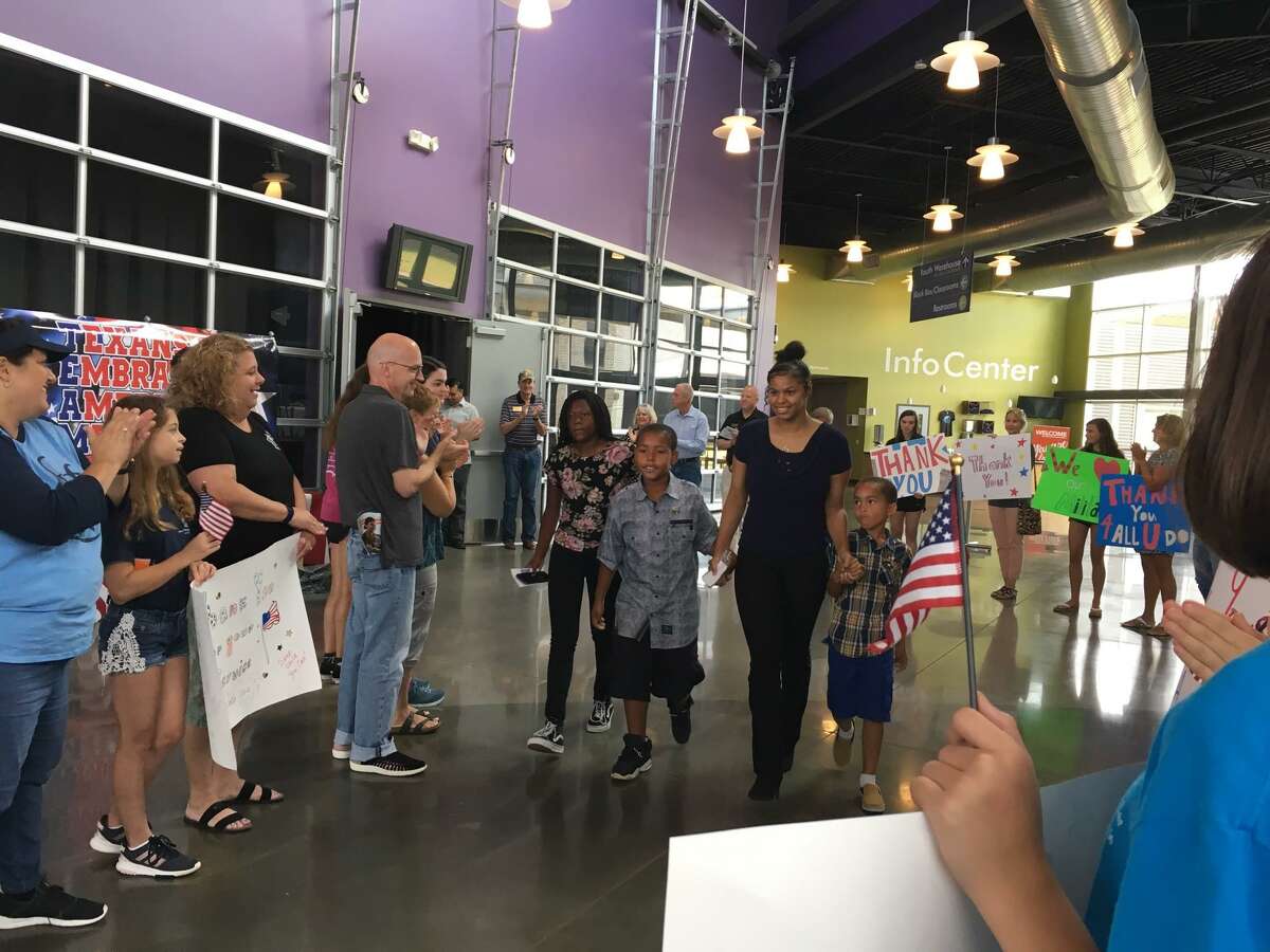 U.S. Army Recruit Jayanna Duckworth walks with her family through a throng of well-wishers at send off organized by Texans Embracing America’s Military. The crowd includes members of nonprofits, first responders, elected officials and other supporters.