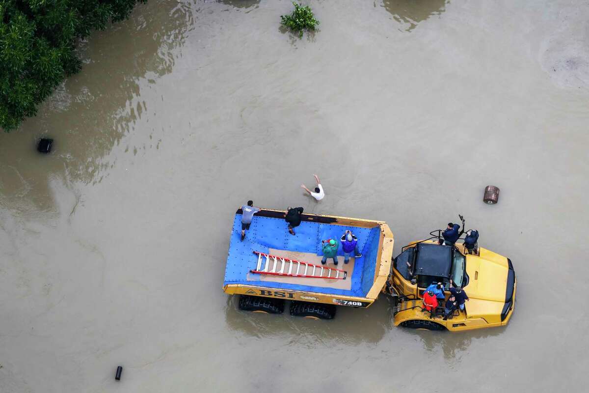 Flood victims are evacuated on a large truck in a neighborhood flooded by Tropical Storm Harvey on Aug. 29, 2017, in Houston.