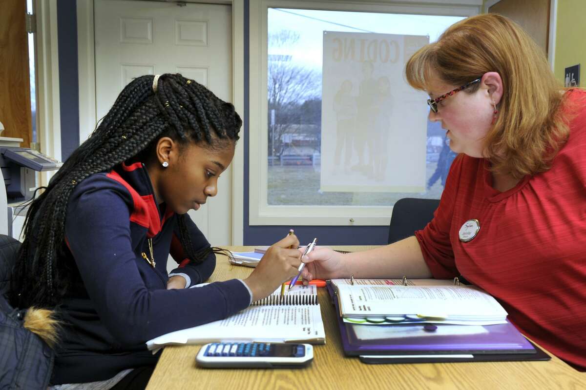 Zhane Dimmitt, 16, left, then a junior at Danbury High School, studies for her SATs with Jennifer Berth, co-director of the Sylvan Learning Center in Brookfield in 2016. A small number of colleges have stopped using standardized tests as an acceptance requirement, while others still use them.