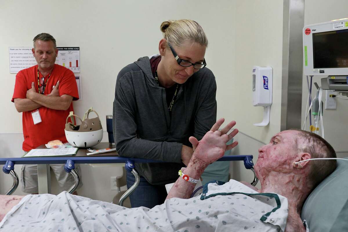 DJ Sutterfield and her husband, Karl Sutterfield, wait with their son, Zachary Sutterfield, before he has hypertrophic burn scar laser surgery at the U.S. Army Institute of Surgical Research Burn Center at Fort Sam Houston. Zachary suffered third-degree burns over nearly 70 percent of his body when someone deliberately set a fire at a San Marcos apartment building last summer. On Friday, authorities announced that the reward for tips had been dramatically increased.
