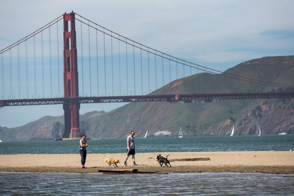 People enjoy sunny day on the beach at Crissy Field on Sunday, March 31, 2019. San Francisco, Calif.