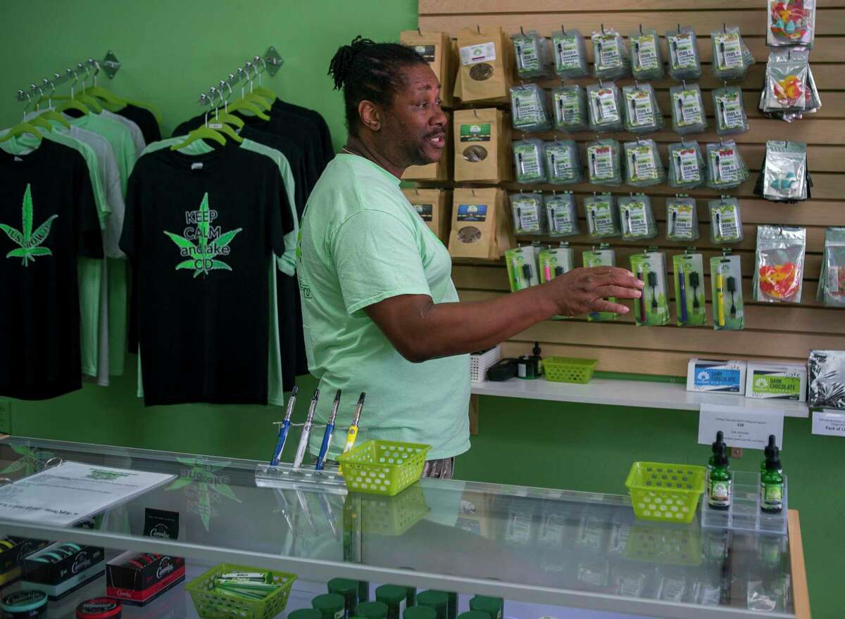 Ron Fleming talks to manager Caroline Mallon about a customer who will be returning to Sacred Leaf, a store that specializes in selling products that contain CBD, later that afternoon in Katy, TX, Monday, July 22, 2019. CBD provides many of the benefits of marijuana without the high and is legal in Texas.