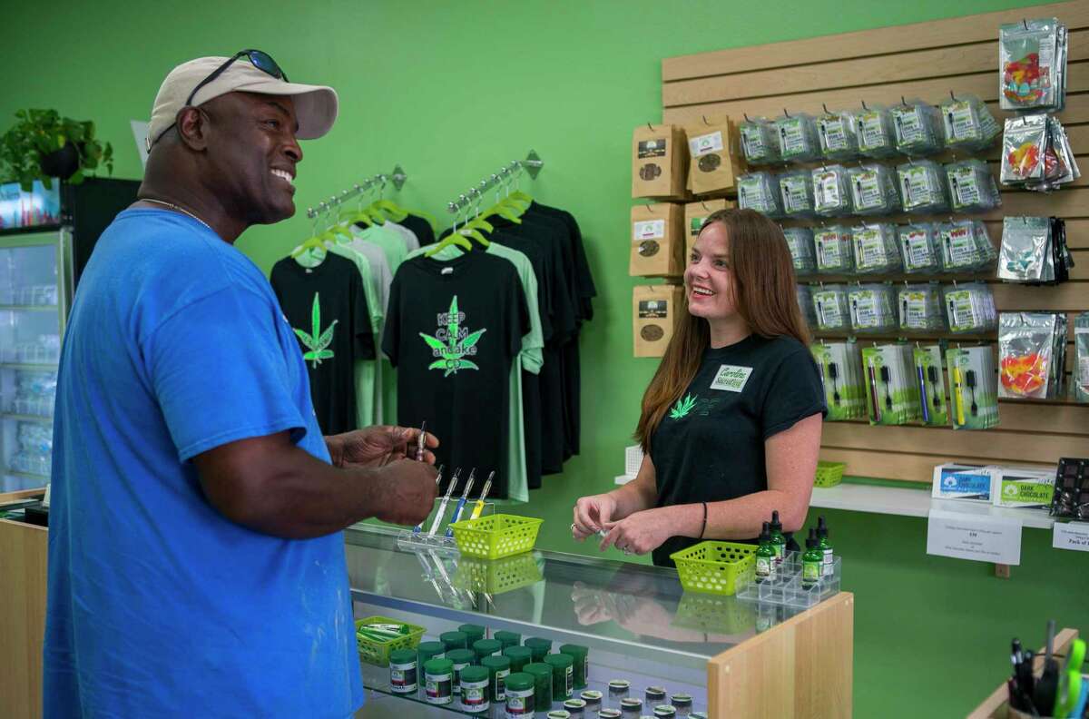 Francis Jones smiles as he talks about his experience using CBD to manage knee and back pain with manager Caroline Mallon at Sacred Leaf, a store that specializes in selling products that contain CBD, in Katy, TX, Monday, July 22, 2019. "I haven't moved my knee like this in years," said Jones, who said he has had four procedures on his knees and two on his back. Jones started using products containing CBD at the recommendation of a friend, and he said he's sleeping better and not experiencing the chronic pain that had previously plagued him. "This stuff has changed my life," said Jones. CBD provides many of the benefits of marijuana without the high and is legal in Texas.