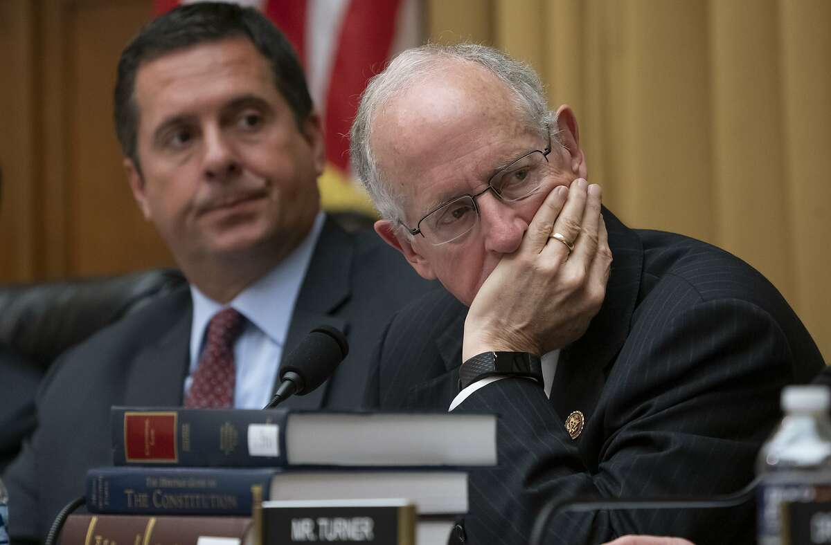 In this July 24, 2019 photo, Rep. Devin Nunes, R-Calif., left, the ranking member of the House Intelligence Committee, and Rep. Mike Conaway, R-Texas, listen as former special counsel Robert Mueller testifies to the House Intelligence Committee about his investigation into Russian interference in the 2016 election, on Capitol Hill in Washington. 