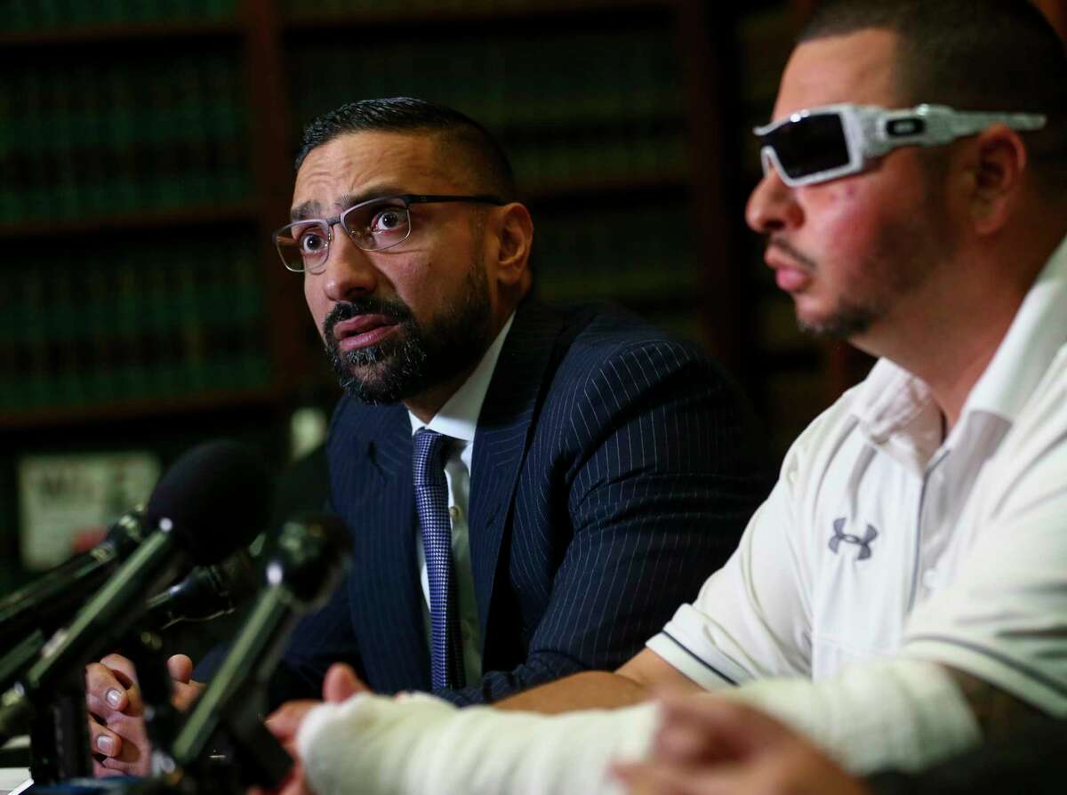 Attorney Muhammad Aziz, left, talks to reporters about the lawsuit filed today against Exxon Mobil Corporation on behalf of Alvaro Coronel on Friday, Aug. 2, 2019, in Houston. Coronel, right, was badly burned in the fire at Exxon Mobil Corporation’s Olefins Plant in Baytown, Texas on Tuesday.