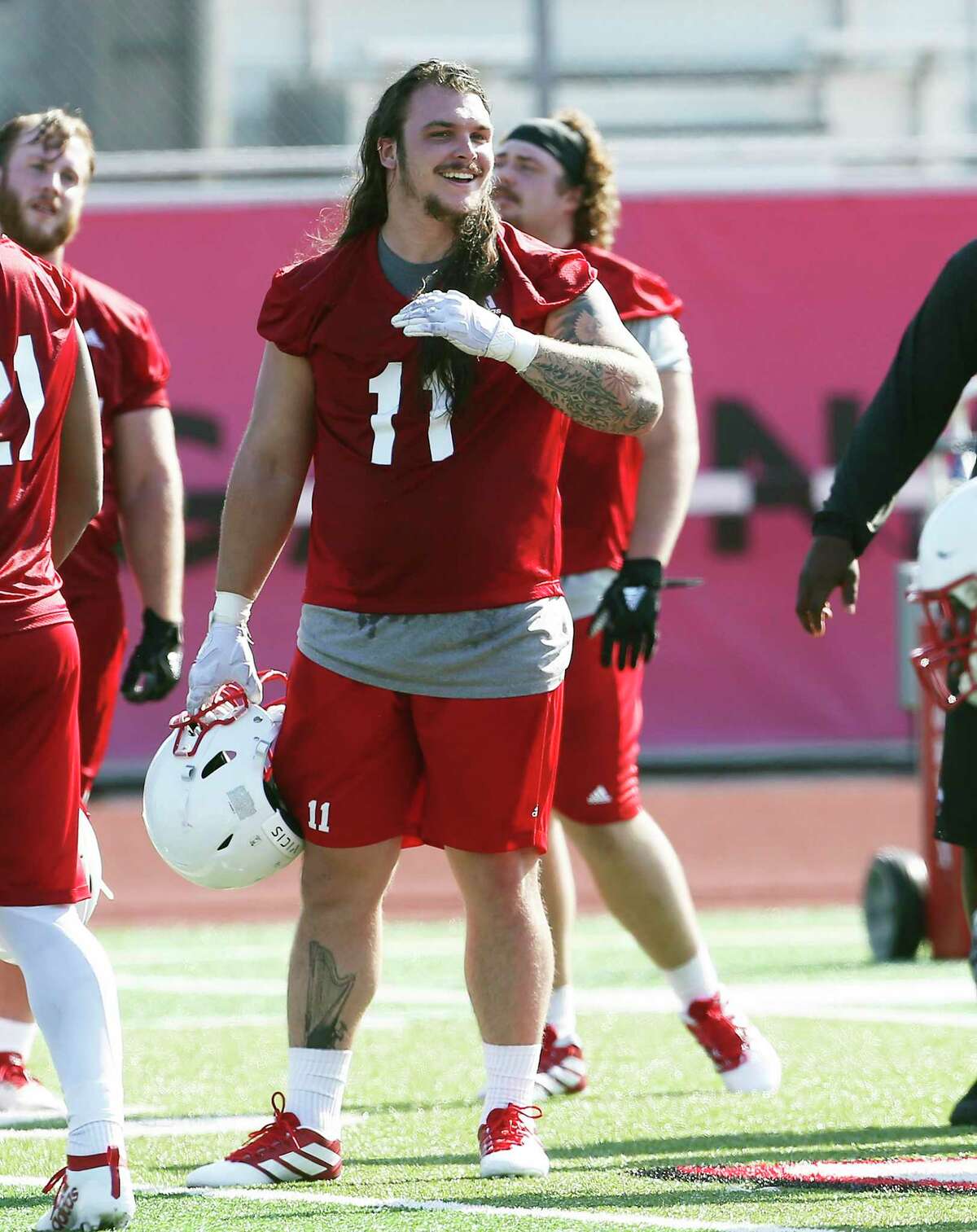 Lukas Termin enjoys company on the field as the Incarnate Word football team holds its first practice of the season at Benson Stadium on August 2, 2019.