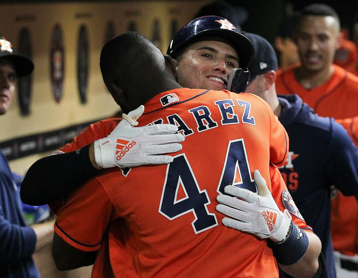 Houston Astros second baseman Aledmys Diaz (16) receives a hug from Yordan Alvarez (44) after hitting a homer during the fifth inning of an MLB baseball game at Minute Maid Park Friday, Aug. 2, 2019, in Houston.