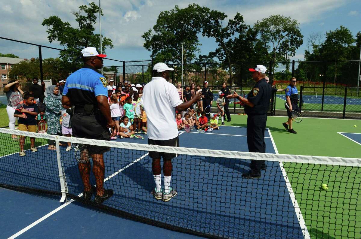 Members of the Community Police Services Division took to the tennis courts with campers from Norwalk Grassroots Tennis & Education Friday, August 2, 2019, at the tennis courts at Nathaniel Ely School in Norwalk, Conn. The annual visits to the program are an effort to form positive relationships with Norwalk’s underserved youth. Norwalk PAL, a nonprofit that provides cultural, educational and athletic experiences to local children, has consistently donated money to the program. Each year, officers join the children for a friendly volley on the Nathaniel Ely School tennis courts.