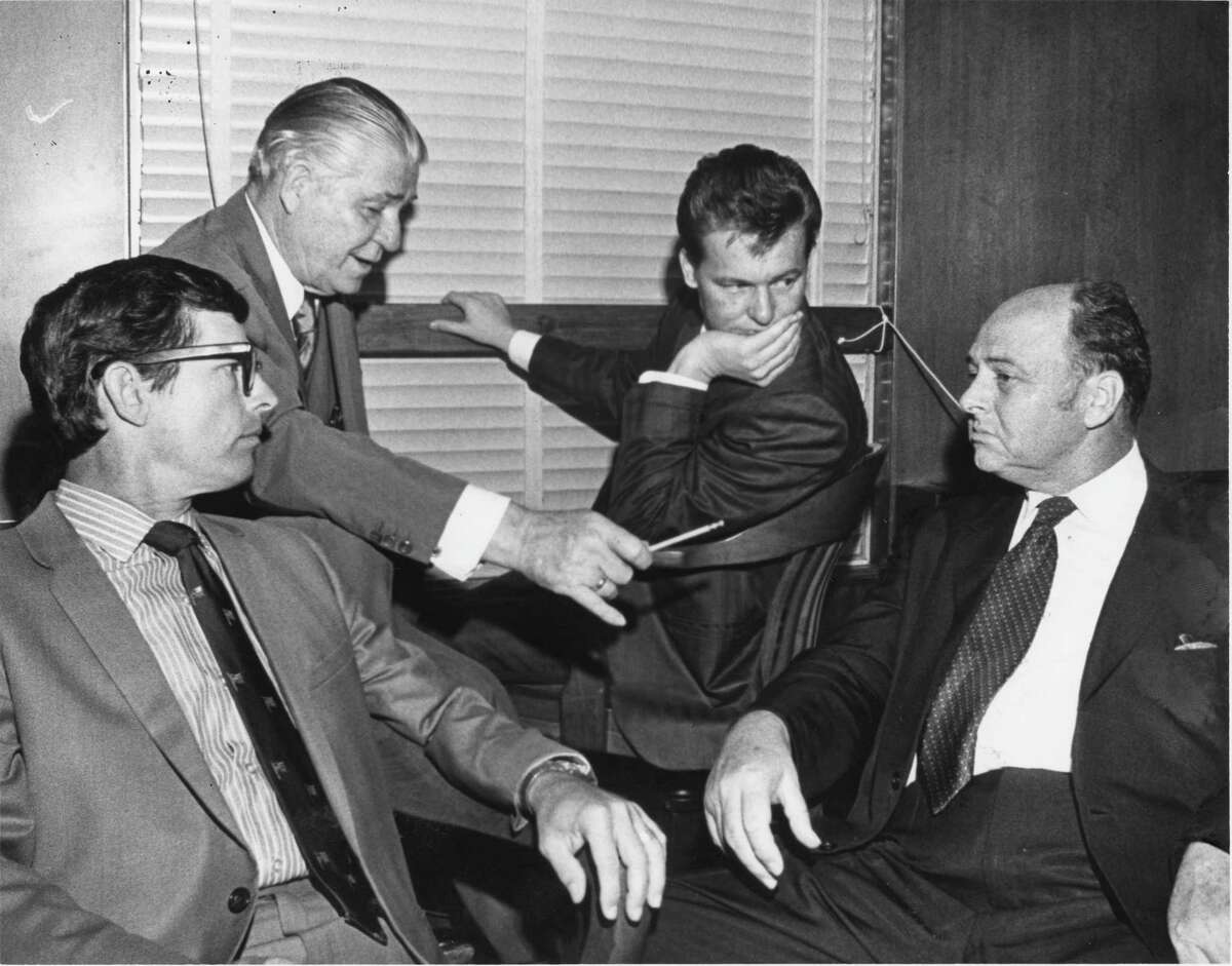 Aug. 12, 1970: Charles V. Harrelson, pictured here third from the right moments after pleading not guilty in the murder of Houston carpet executive Alan Harry Berg, confers with Percy Foreman and other attorneys. Harrelson was eventually found not guilty in Berg’s death – only to move on and assassinate U.S. District Judge John H. Wood in San Antonio.Charles Harrelson is the father of actor Woody Harrelson. 