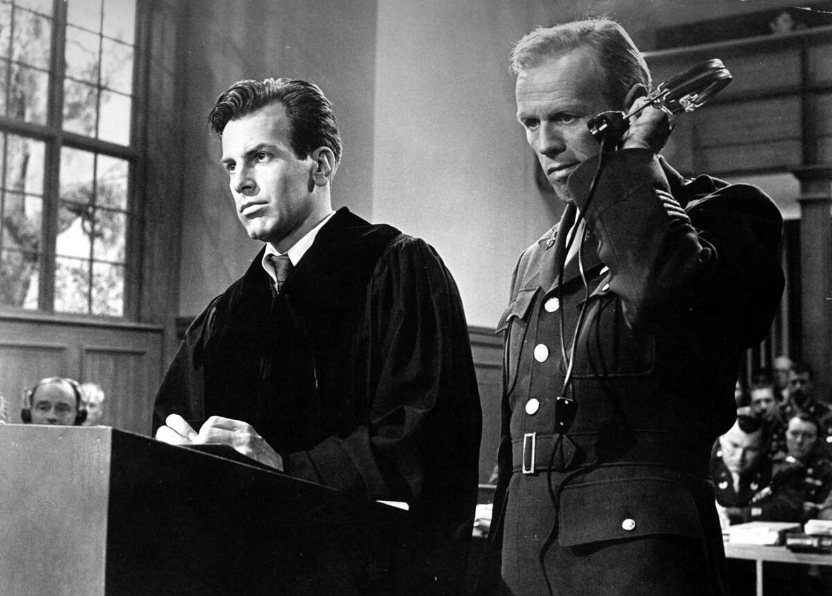 In this 1962 image originally released by United Artists, Richard Widmark portrays Col. Tad Lawson, right, in a scene with Maximilian Schell in "Judgment at Nuremberg."