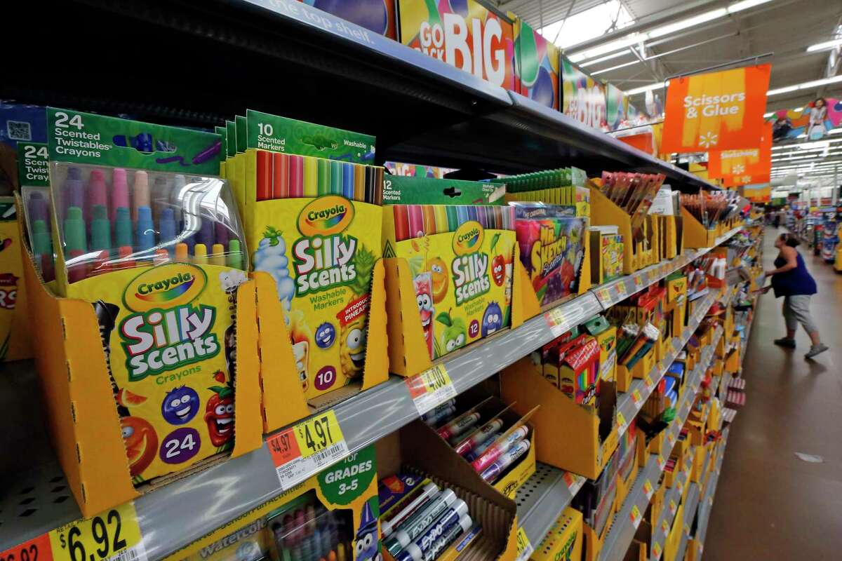 FILE- This July 19, 2018, file photo shows a display of scented markers and crayons in a Walmart in Pittsburgh. Environmentally friendly school supplies often carry big prices, but if you expand your idea of what counts as “green,” you’ll open other ways to save. (AP Photo/Gene J. Puskar, File)