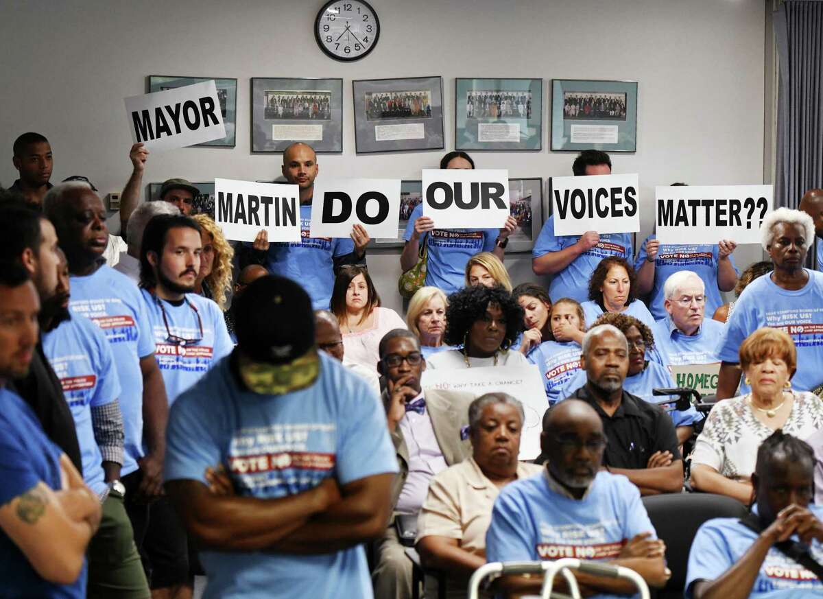 Stamford residents show their disapproval of the appointment of Chris Murtha as Police Chief during the Board of Representatives vote at the Government Center in Stamford, Conn. Monday, Aug. 5, 2019. Some officers and Stamford residents have objected to the appointment of Murtha, who currently serves as Deputy Chief in Prince George’s County Police Department in Maryland. Murtha was named in a civil suit in which black and Latino officers alleged that he and other commanders showed racial bias in deciding promotions, transfers, work hours, assignments and disciplinary action.