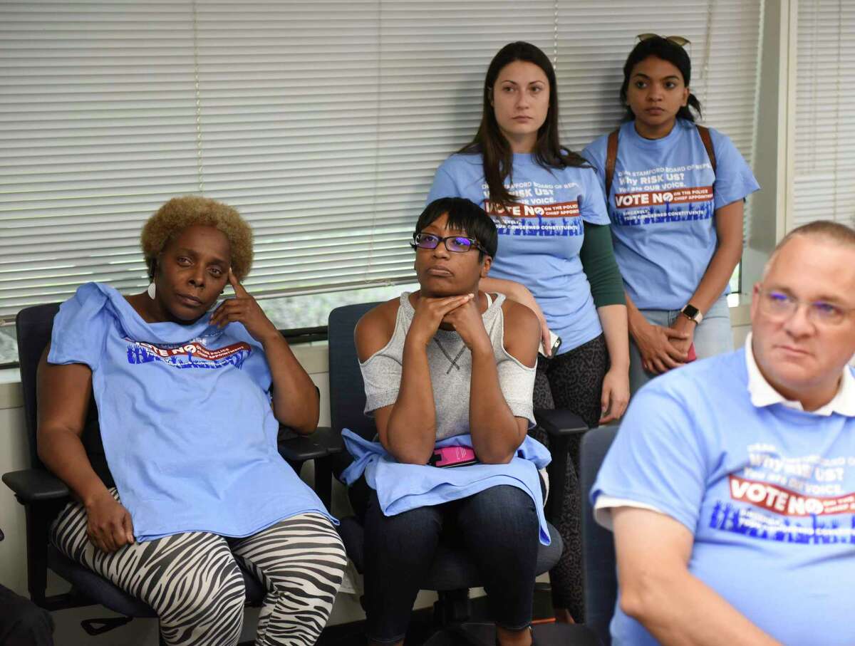 Stamford residents watch the Board of Representatives vote on the appointment of Chris Murtha as Police Chief from an overflow room at the Government Center in Stamford, Conn. Monday, Aug. 5, 2019. Some officers and Stamford residents have objected to the appointment of Murtha, who currently serves as Deputy Chief in Prince George’s County Police Department in Maryland. Murtha was named in a civil suit in which black and Latino officers alleged that he and other commanders showed racial bias in deciding promotions, transfers, work hours, assignments and disciplinary action.