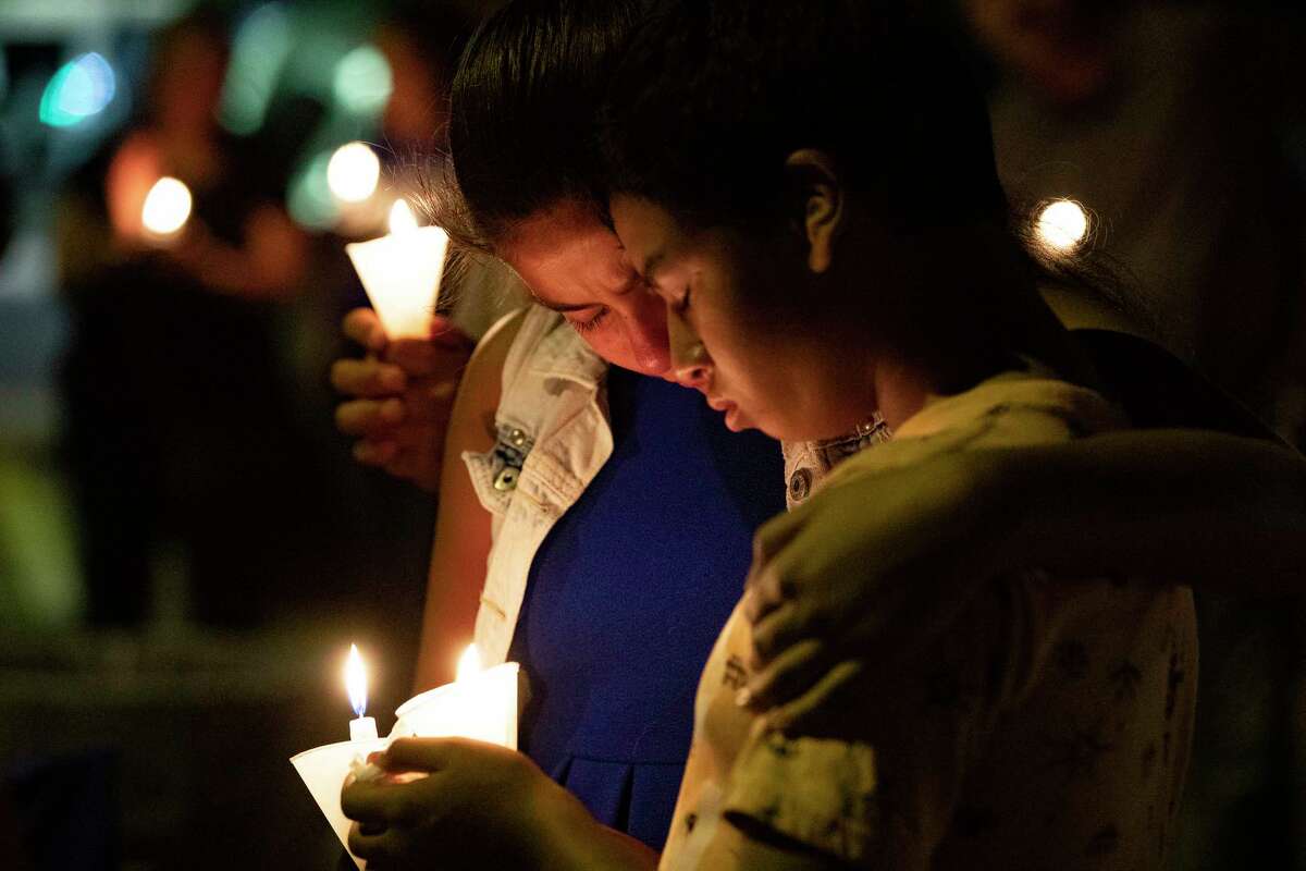 Mourners hug each other during a prayer candle vigil Monday, Aug. 5, 2019, in El Paso. The event was organized by the Immanuel Church in support of the victims of the El Paso shooting.