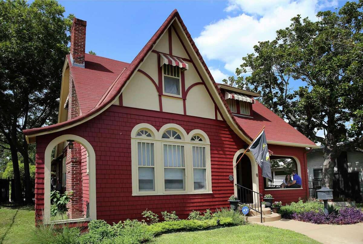 With wood shake siding painted red on the lower walls and stucco and trim in the gables Rachel and Larkin O’Hern’s Tobin Hill home is in the English Cottage style with an exaggerated, fairy tale roofline.