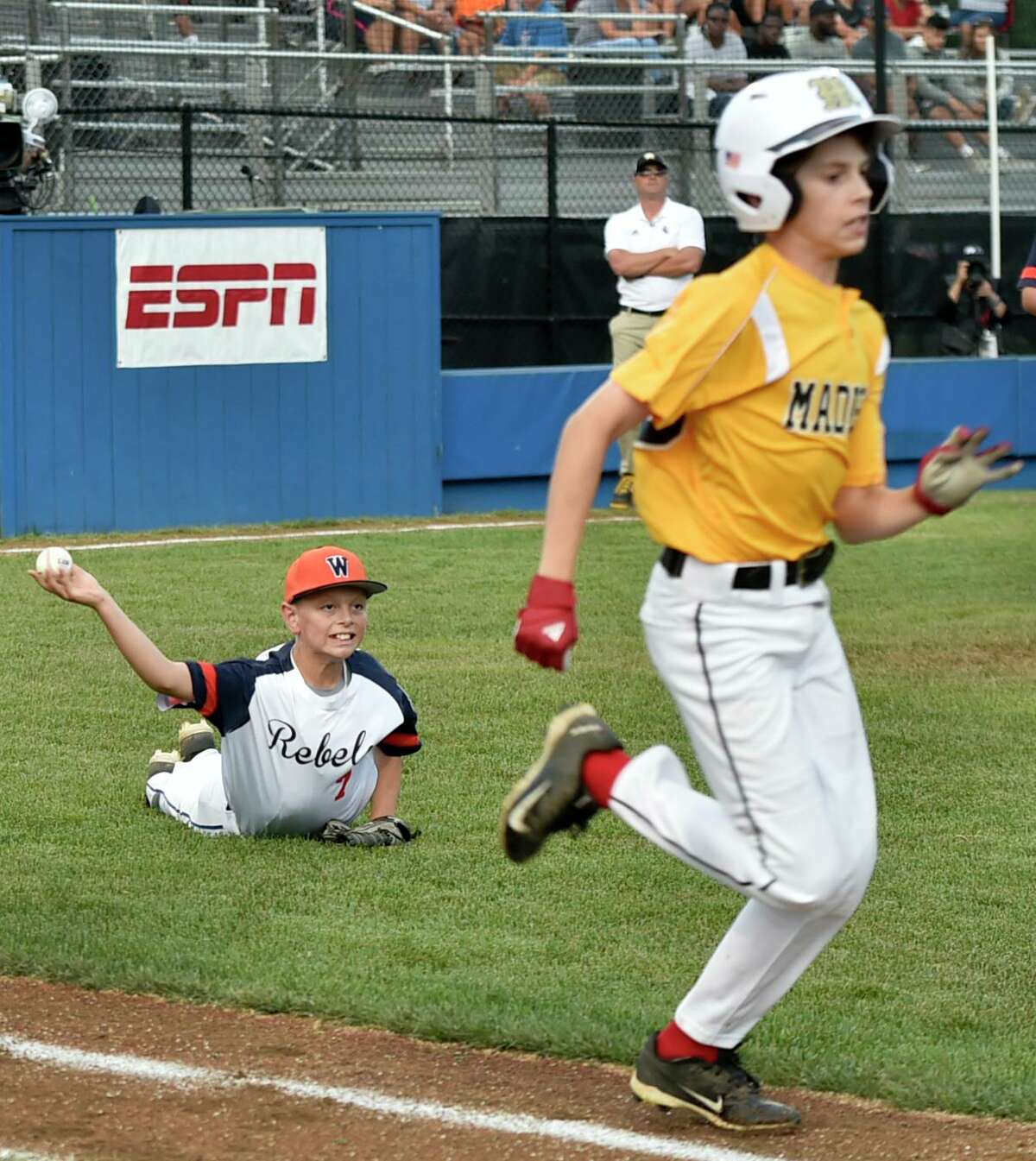 Connecticut’s Rocco Zagami runs safely to first base after dropping a bunt against Massachusetts pitcher Beckett Delleo during the Little League Eastern Regional in Bristol on Tuesday.