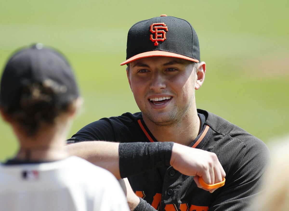 San Francisco Giants' Joe Panik speaks to a young fan before a baseball game against the St. Louis Cardinals, Sunday, Aug. 30, 2015, in San Francisco. (AP Photo/George Nikitin)