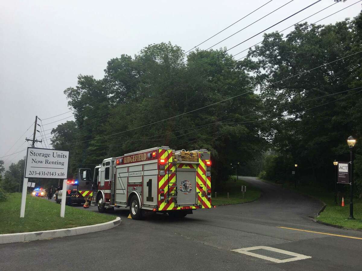 A Ridgefield fire engine arrives at the scene of a downed power line on Old Quarry Road Wednesday, Aug. 7.