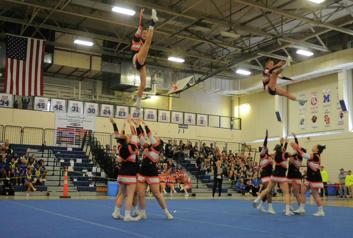 Ridgefield cheer competes during the FCIAC Cheerleading Championship at the Wilton Field House in Wilton, Conn. on Feb. 6, 2016.
